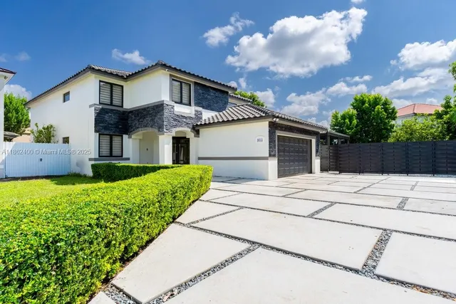 a front view of a house with a garden