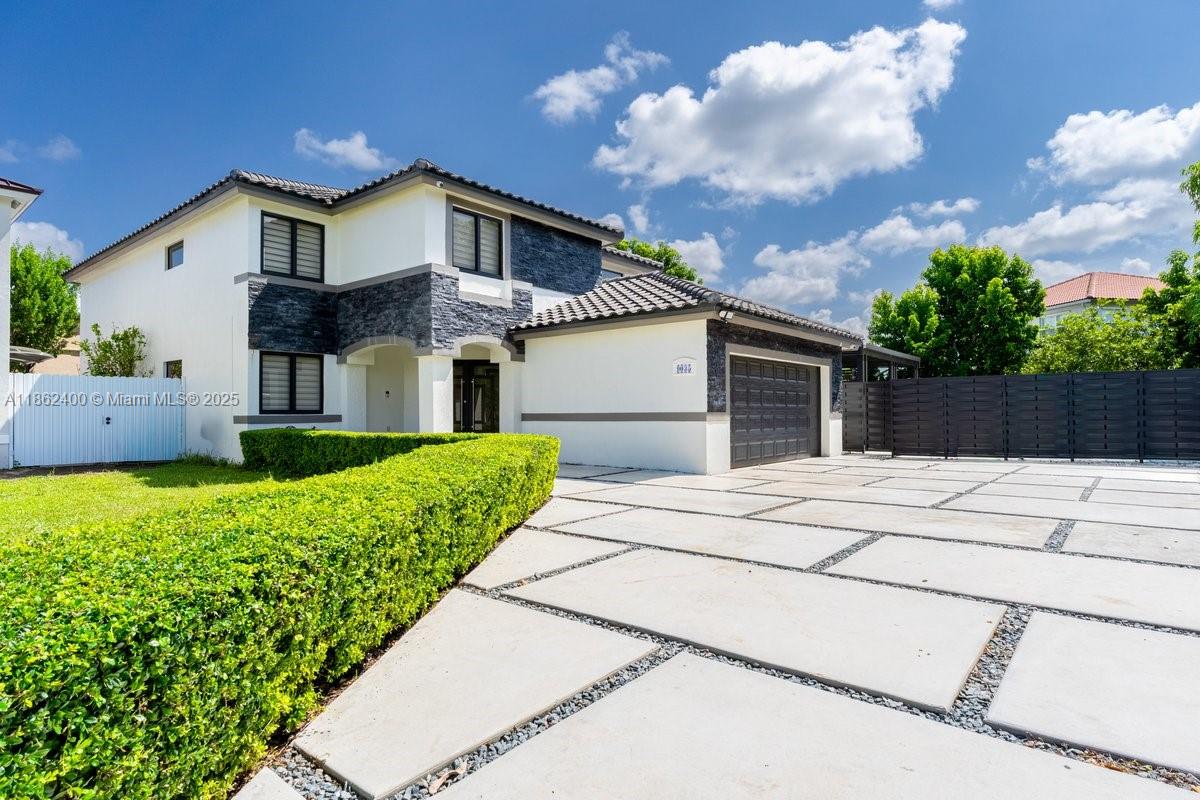 9035 Southwest 156th Court Miami, FL 33196 - Photo 1 of 33 a front view of a house with a garden
