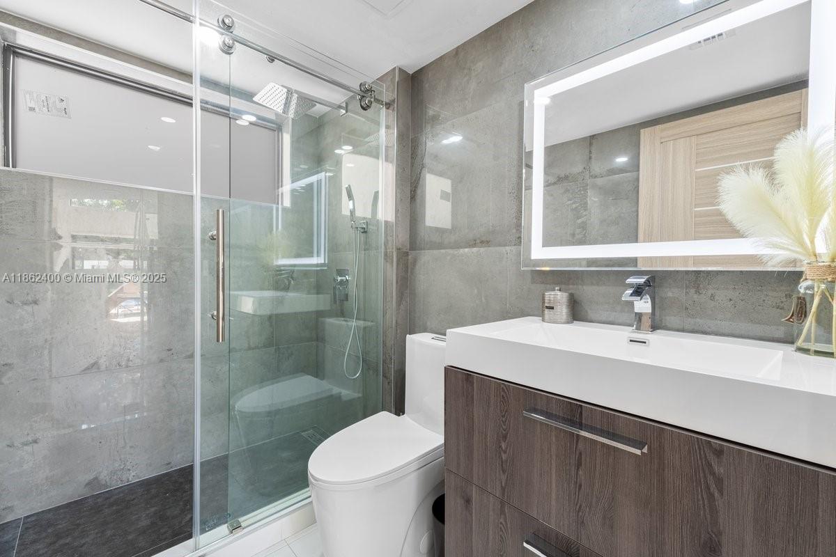 9035 Southwest 156th Court Miami, FL 33196 - Photo 21 of 33 a bathroom with a sink toilet and shower