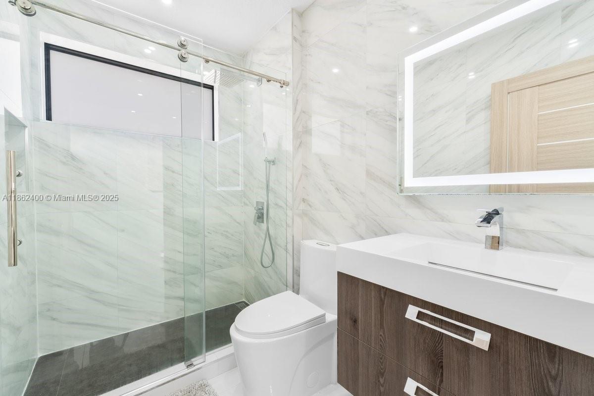9035 Southwest 156th Court Miami, FL 33196 - Photo 22 of 33 a bathroom with a sink a toilet and shower
