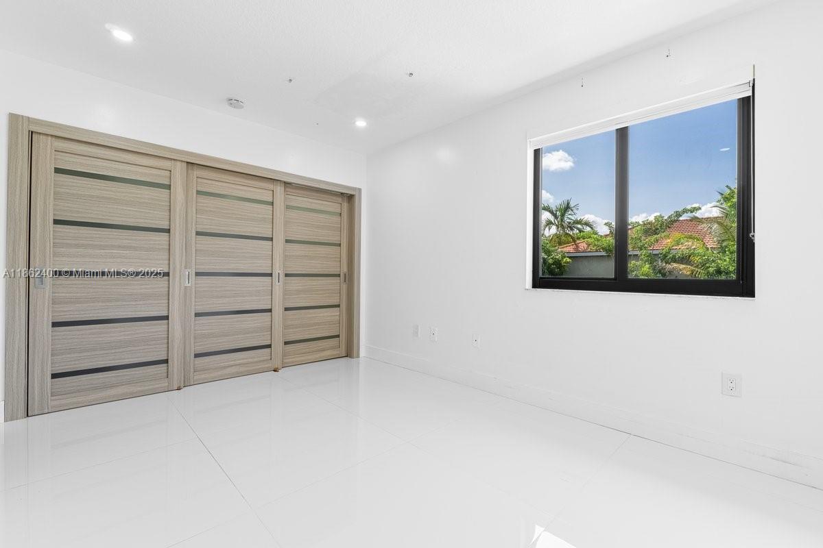 9035 Southwest 156th Court Miami, FL 33196 - Photo 25 of 33 a view of an empty room with a window
