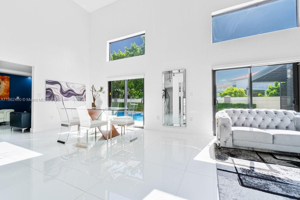 9035 Southwest 156th Court Miami, FL 33196 - Photo 7 of 33 a living room with furniture and a large window