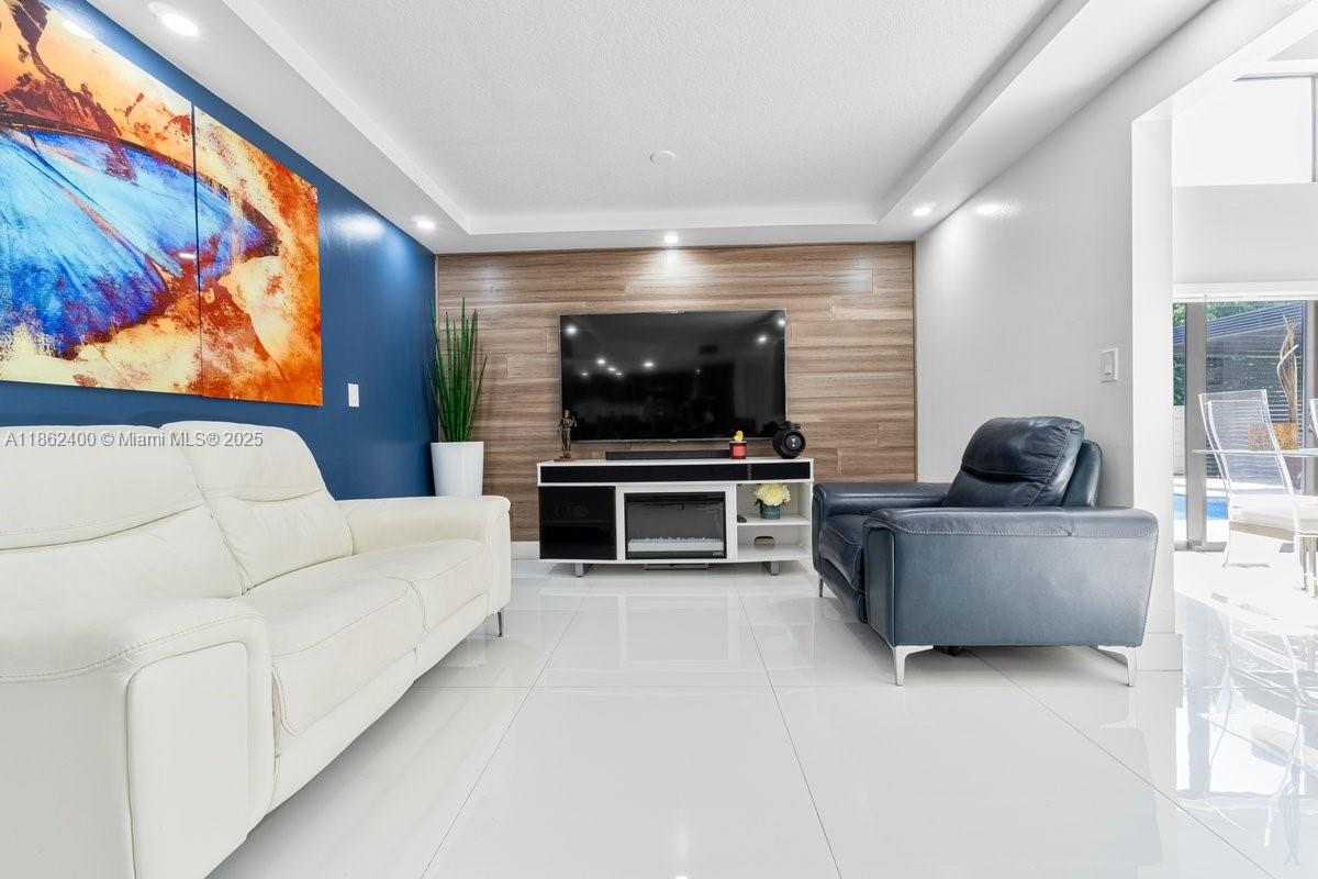 9035 Southwest 156th Court Miami, FL 33196 - Photo 8 of 33 a living room with furniture and a flat screen tv