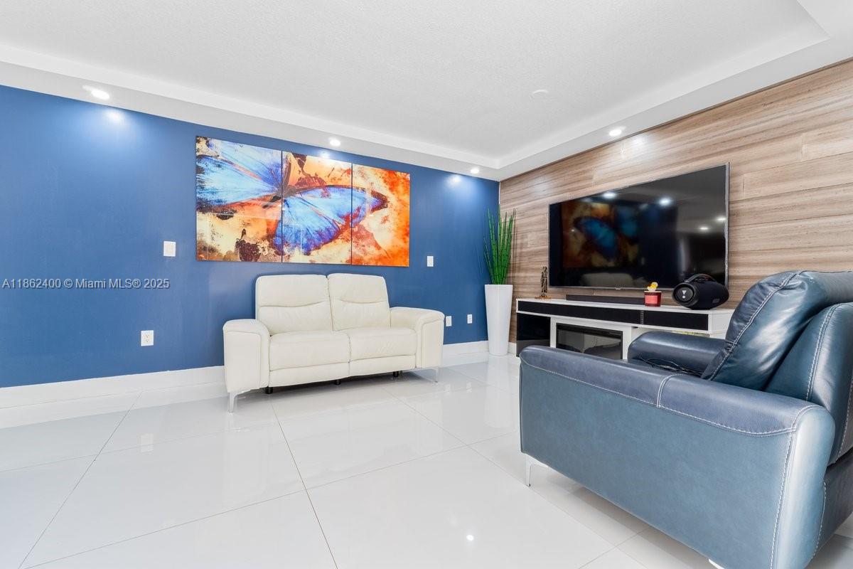 9035 Southwest 156th Court Miami, FL 33196 - Photo 9 of 33 a living room with furniture and a flat screen tv