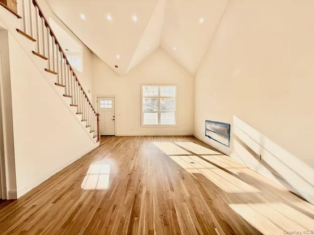 a view of an empty room and wooden floor