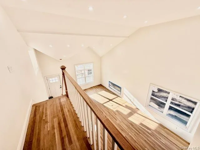 a view of a room with wooden floor