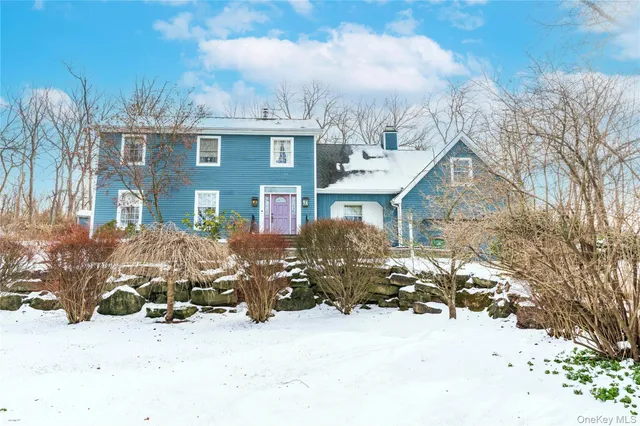 a view of a house with a yard covered in snow