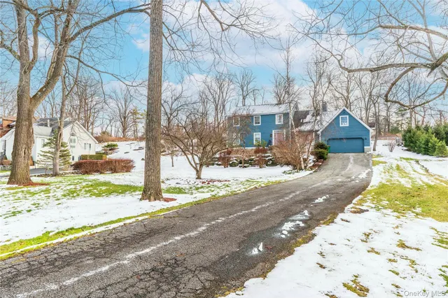 a view of a house with snow on the road