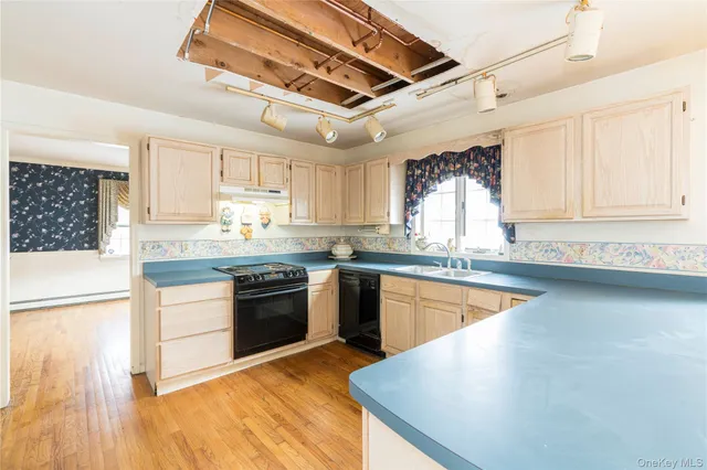a kitchen with sink cabinets and wooden floor