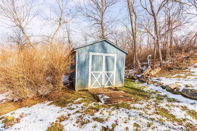 a house that has a tree in front of a house