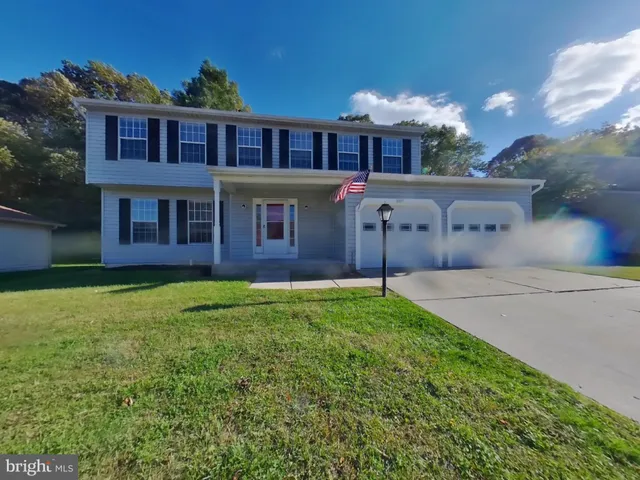 a view of a house with a backyard and porch