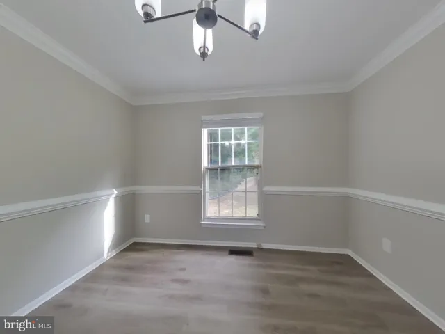 an empty room with a empty space and windows