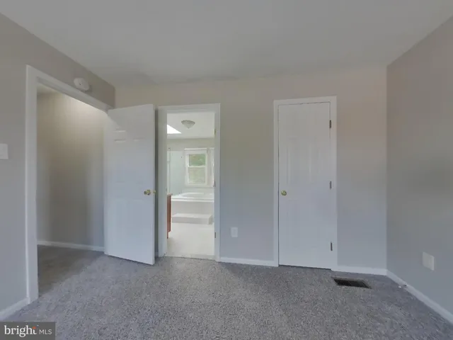 a view of an empty room and closet area