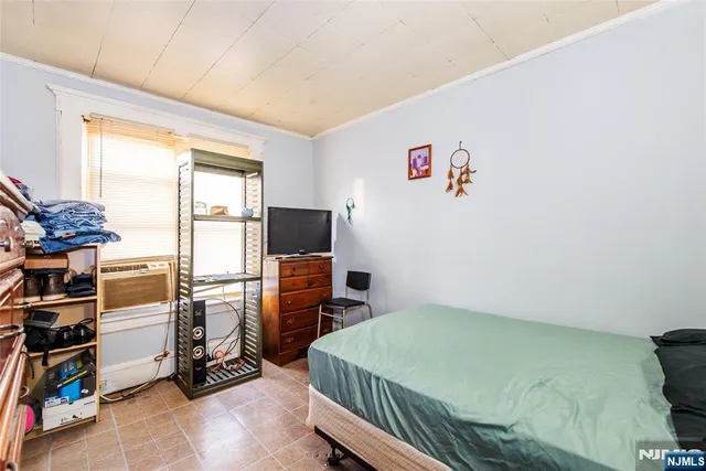 a bedroom with furniture and a window