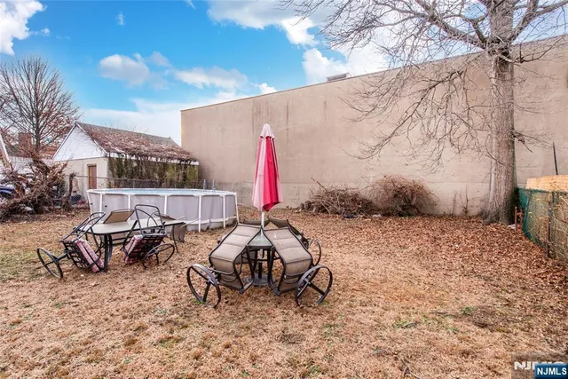 a view of backyard with a table and chairs