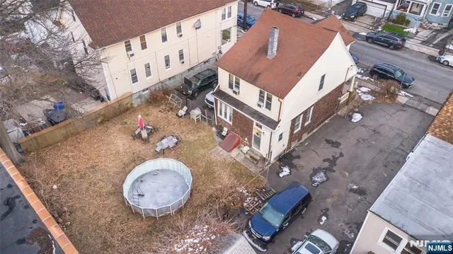 an aerial view of a house with a backyard