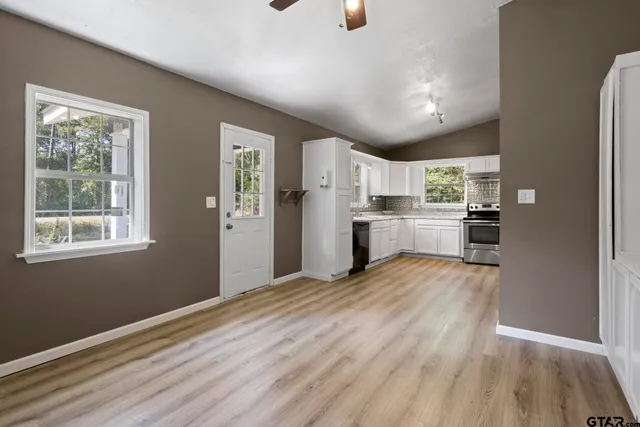 a kitchen with stainless steel appliances granite countertop a refrigerator and a stove top oven
