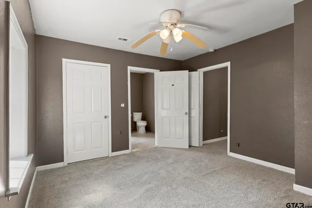 a view of a livingroom with a chandelier fan and closet