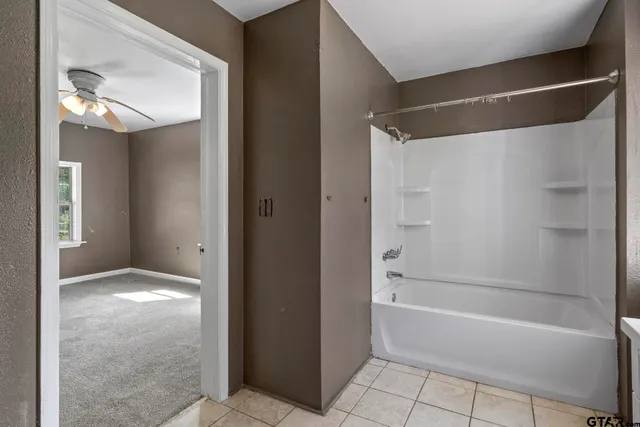 a bathroom with a bathtub and a shower