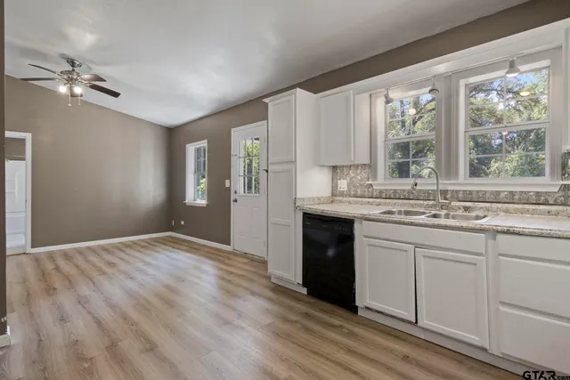 a kitchen with a sink cabinets and appliances