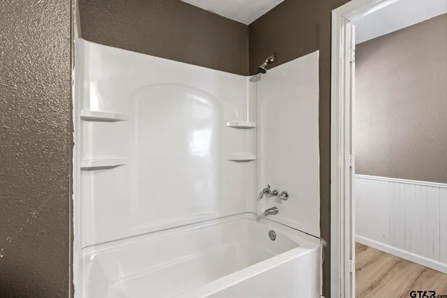 a bathroom with a bathtub and a shower