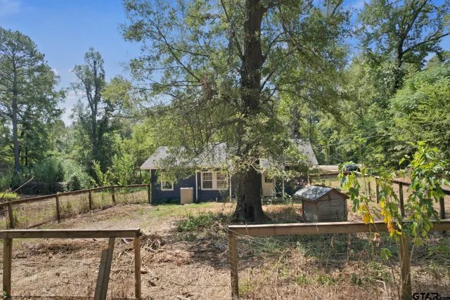 a view of a house with large tree