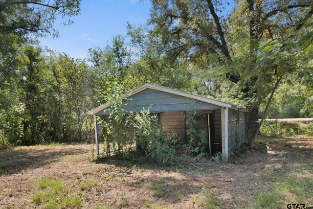 a tree is in front of a house