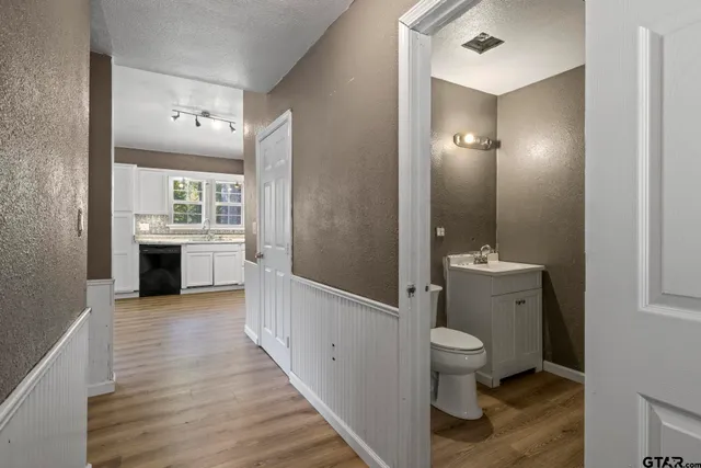 a spacious bathroom with a toilet sink and mirror