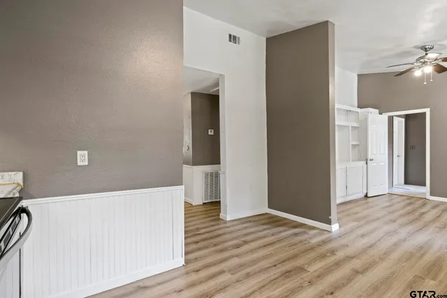 a view of hallway with wooden floor