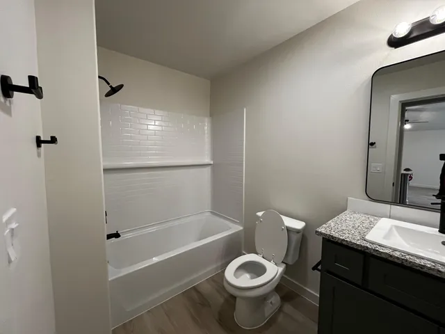 a bathroom with a sink toilet and shower