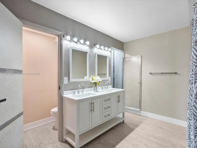 a bathroom with a double vanity sink and mirror