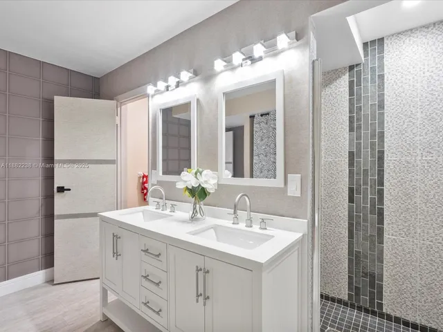 a bathroom with a sink double vanity and a mirror