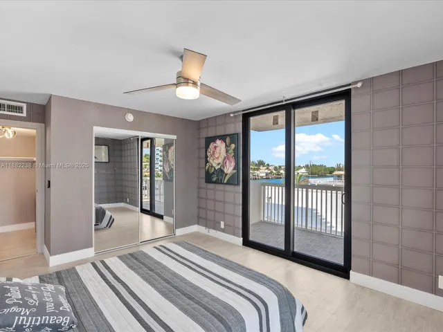 a bedroom with a large bed and a large window