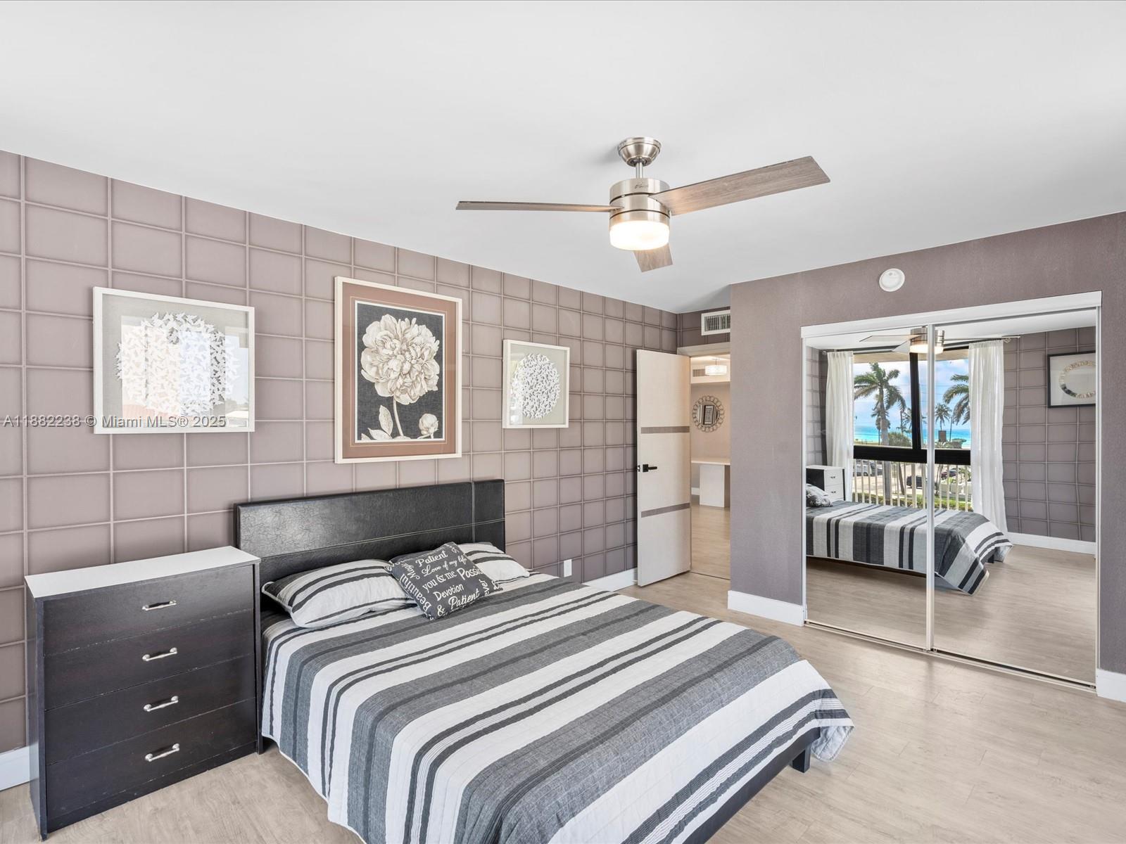 1500 South Ocean Drive, Unit 3G Hollywood, FL 33019 - Photo 25 of 37 a bedroom with a large bed and a chandelier