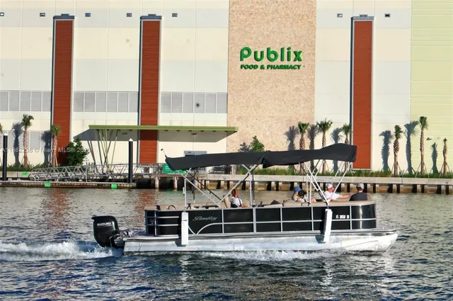 a front view of a water with boats and trees in the background