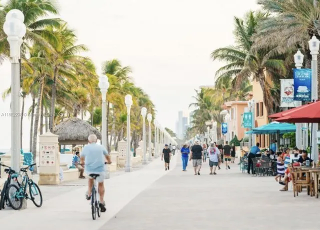 a group of people sitting in a yard in front of a building