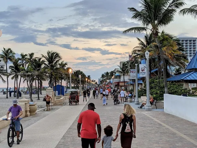 a group of palm trees in front of a house