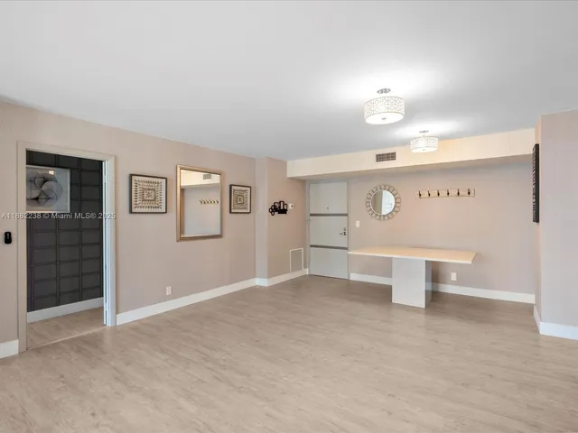 a view of a big room with windows and cabinet