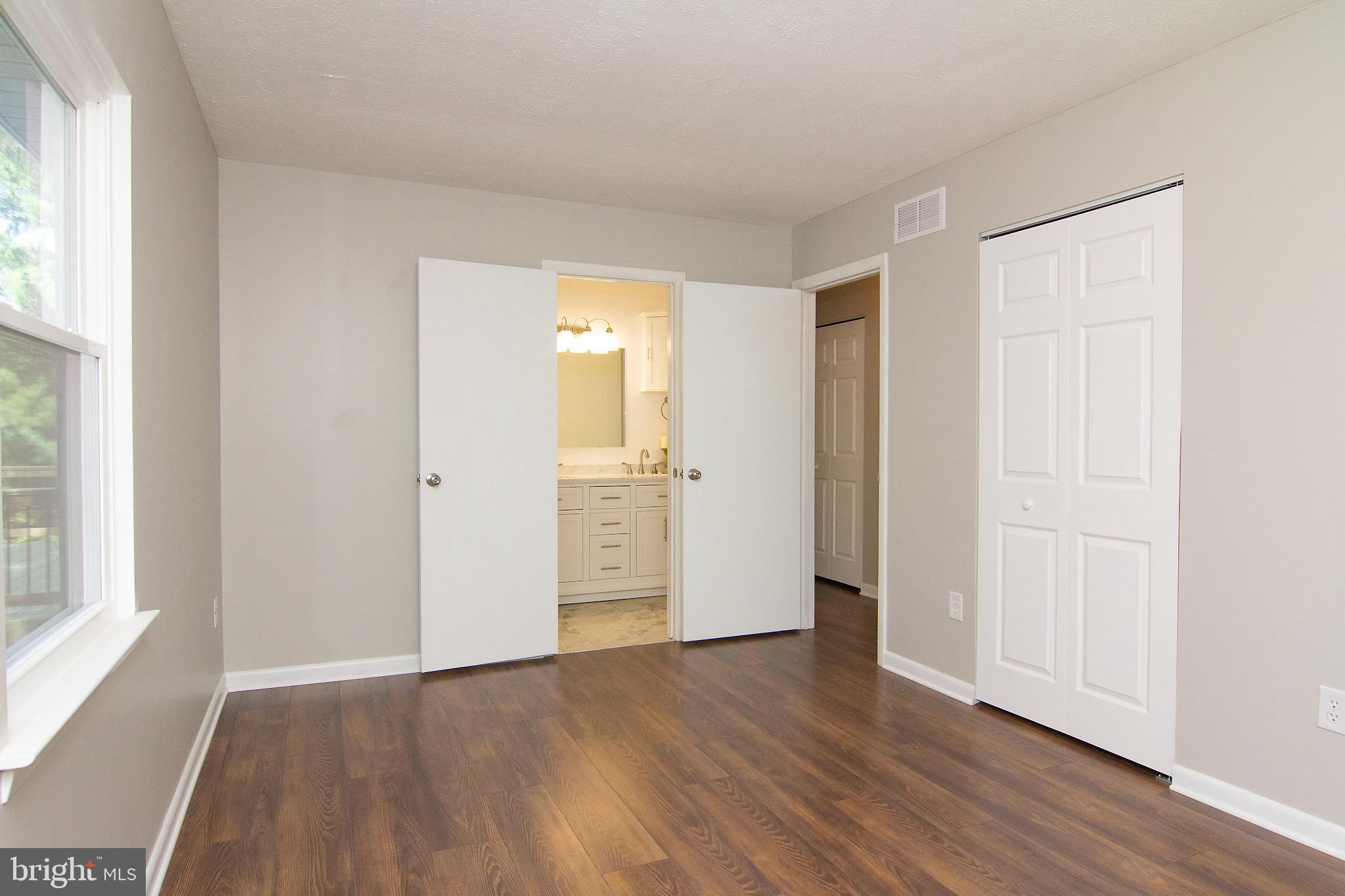 1526 Manchester Road Westminster, MD 21157 - Photo 15 of 41 an empty room with wooden floor and windows