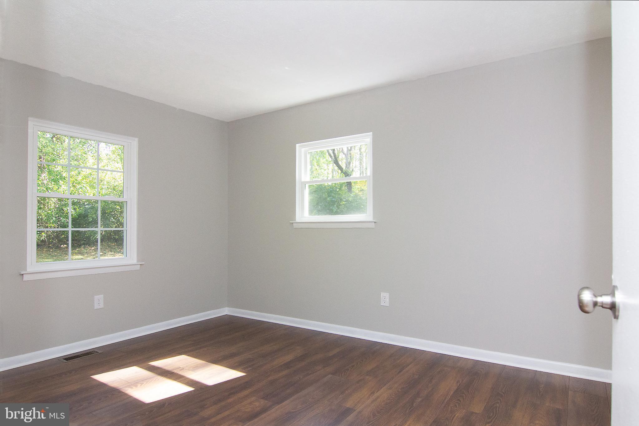 1526 Manchester Road Westminster, MD 21157 - Photo 17 of 41 an empty room with wooden floor and windows