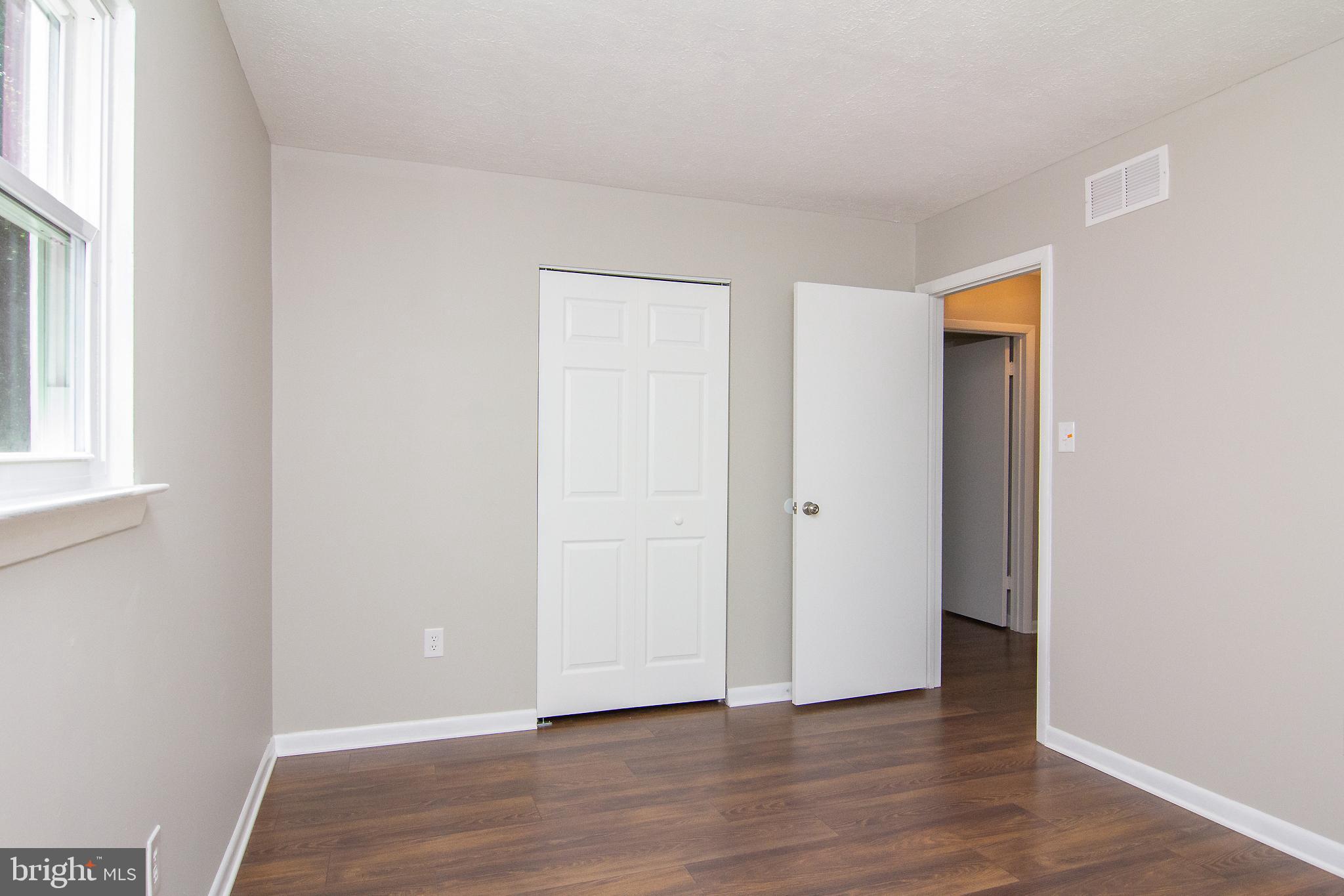 1526 Manchester Road Westminster, MD 21157 - Photo 18 of 41 an empty room with wooden floor and windows