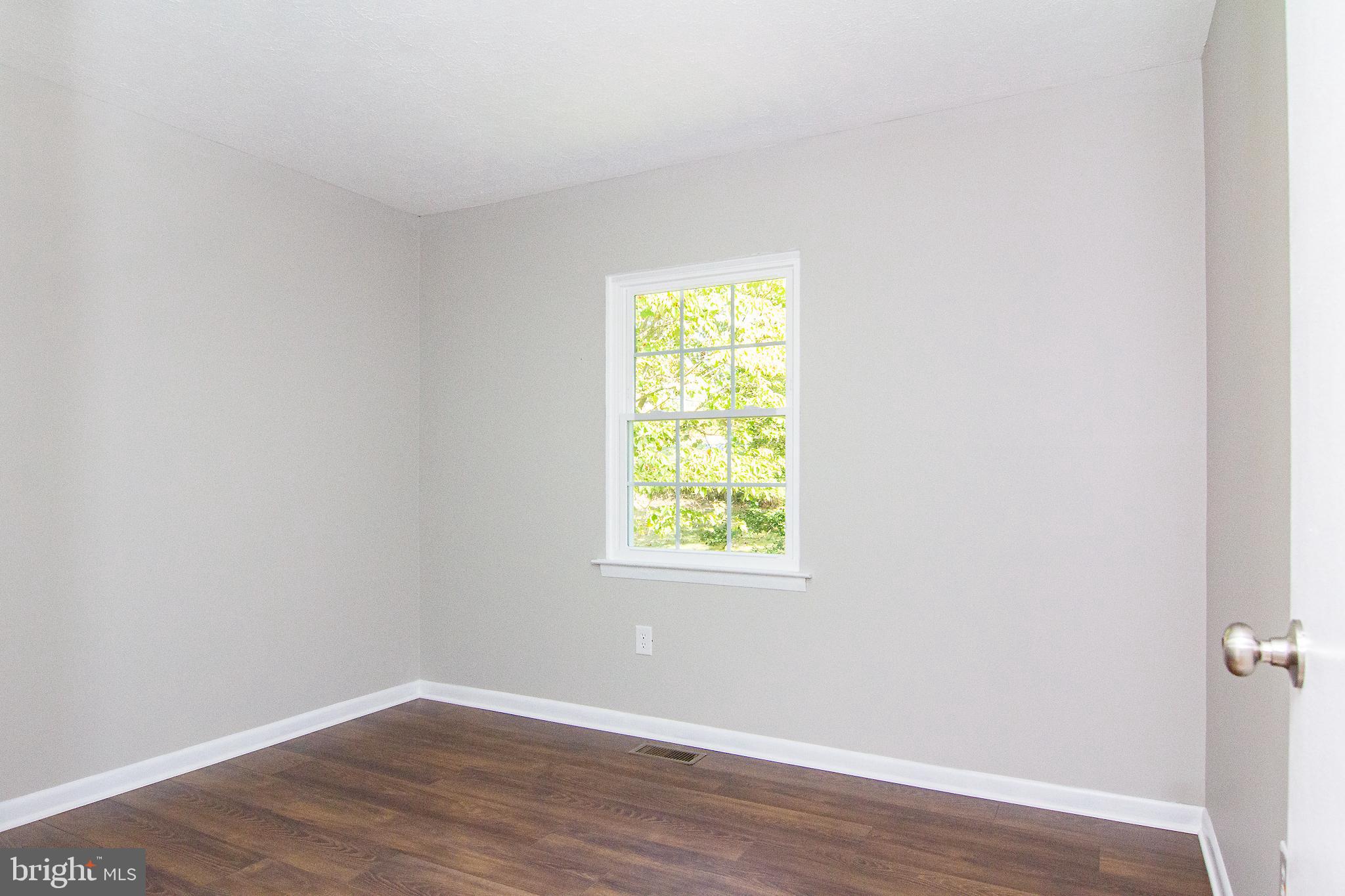 1526 Manchester Road Westminster, MD 21157 - Photo 19 of 41 an empty room with wooden floor and windows