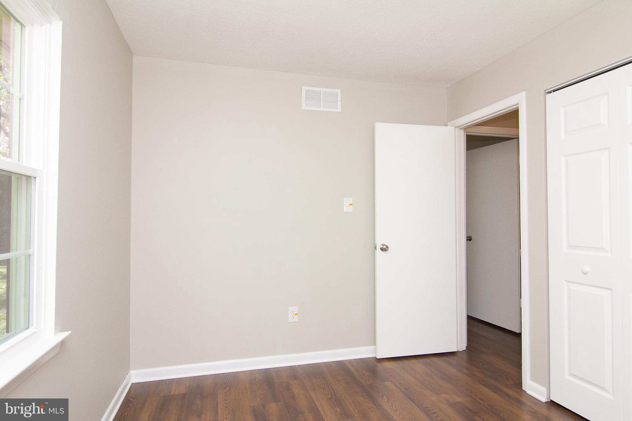 1526 Manchester Road Westminster, MD 21157 - Photo 20 of 41 a view of an empty room with wooden floor and a window