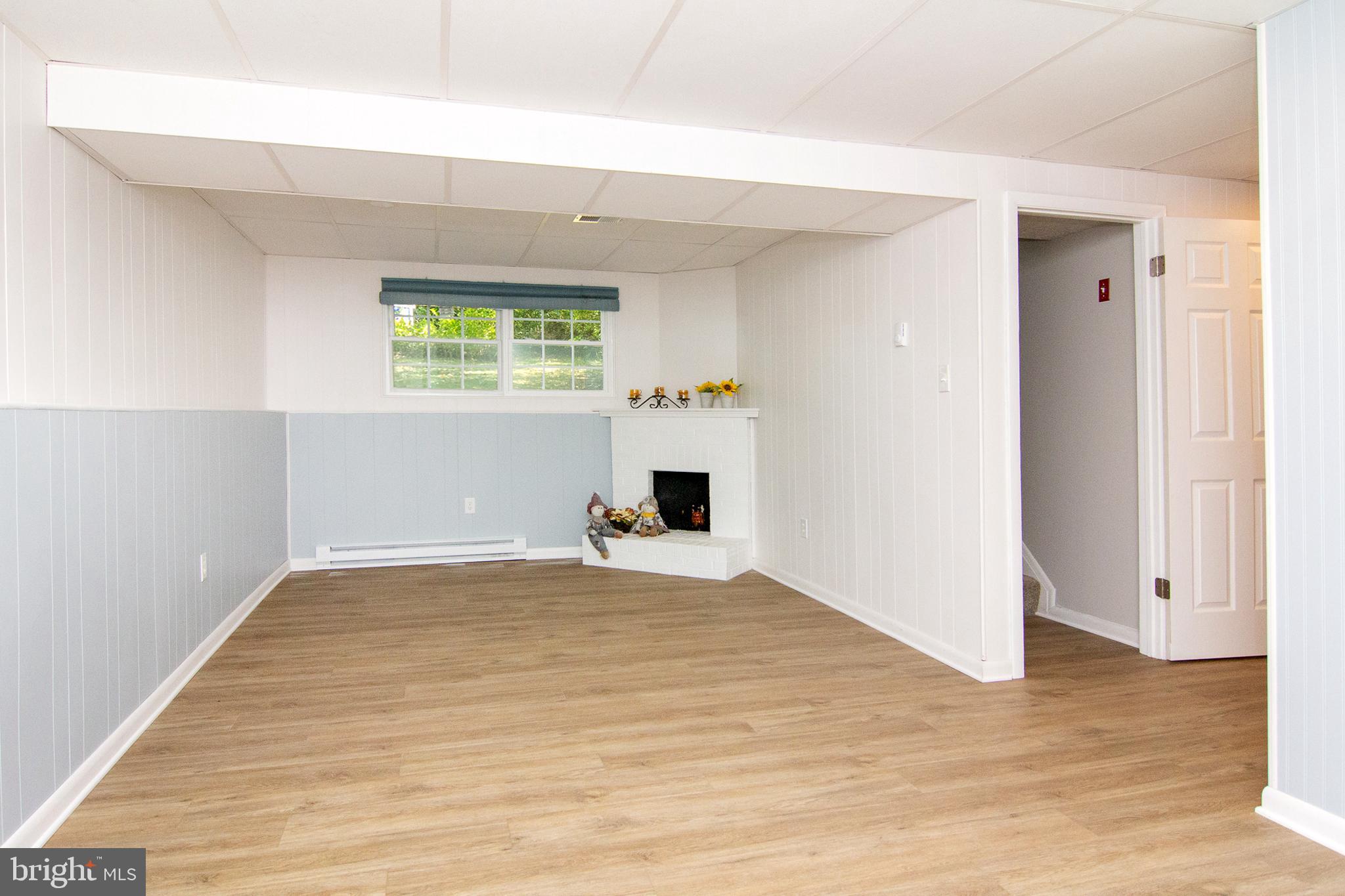 1526 Manchester Road Westminster, MD 21157 - Photo 21 of 41 an empty room with wooden floor and a window