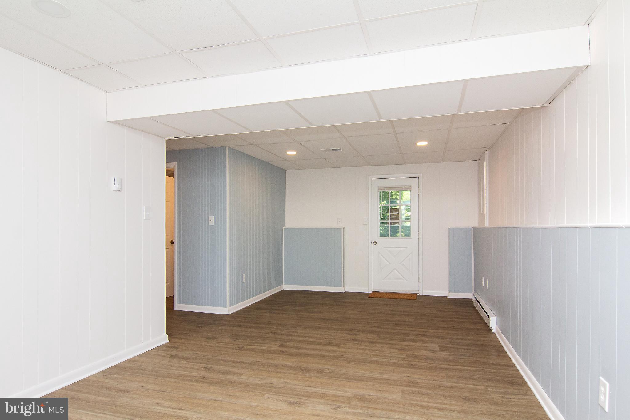 1526 Manchester Road Westminster, MD 21157 - Photo 23 of 41 an empty room with wooden floor and windows