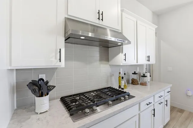 a kitchen with stainless steel appliances a sink and a stove