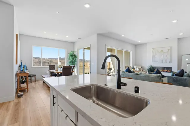 a kitchen with counter top a sink and cabinets