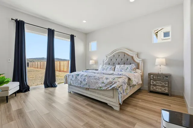 a bedroom with a large bed and a large window