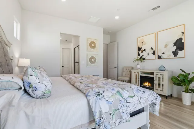 a bedroom with a bed and a fireplace