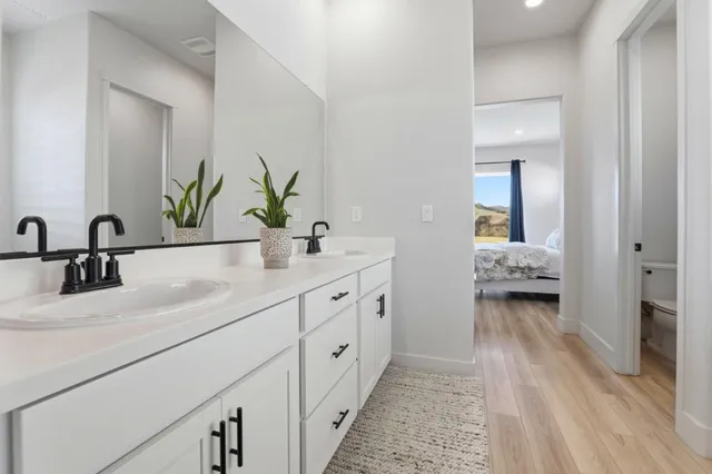 a bathroom with a double vanity sink and a mirror